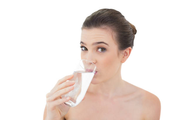 istock Cute natural brown haired model drinking water 852326874