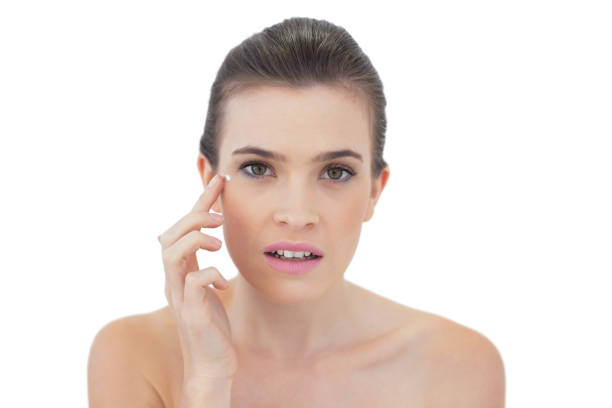 istock Beautiful natural brown haired model applying face cream 852330014