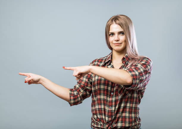 istock Young handsome woman pointing by index fingers 852331854