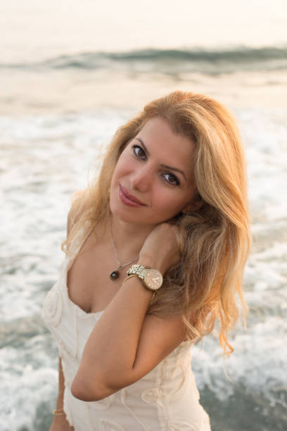 istock Beautiful blonde woman by seaside 852334202