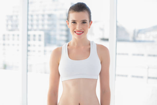 istock Attractive fit brown haired model in sportswear posing looking at camera 852338710