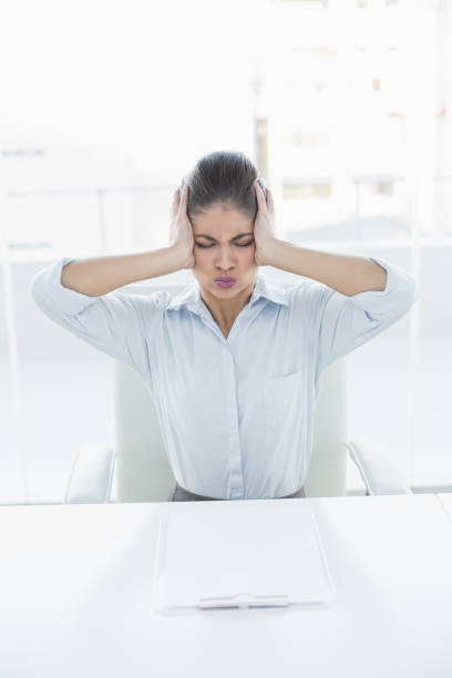 istock Businesswoman suffering from headache at office 852358934