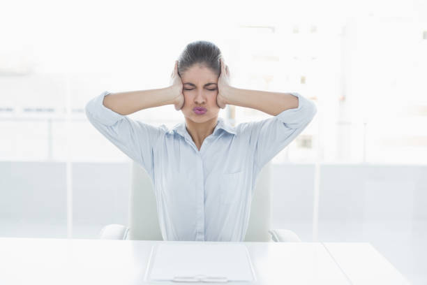 istock Businesswoman suffering from headache at office 852359094