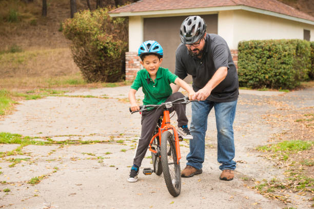 istock California Father Teaching Young Son How to Ride a Bicycle 852394090