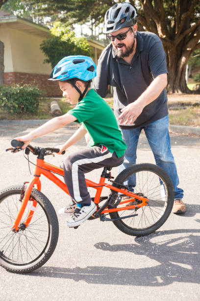 istock California Father Teaching Young Son How to Ride a Bicycle 852396478