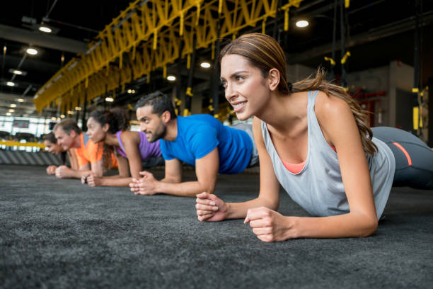 istock Group of people exercising at the gym doing planks 852401356