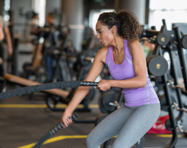 istock Woman exercising at the gym with ropes 852401596