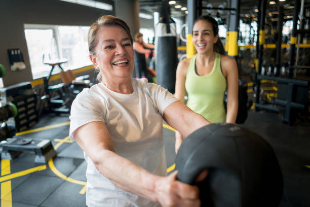 istock Woman exercising at the gym with a personal trainer 852401658