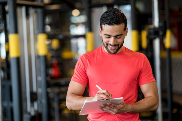 istock Happy man working as a personal trainer at the gym 852401712