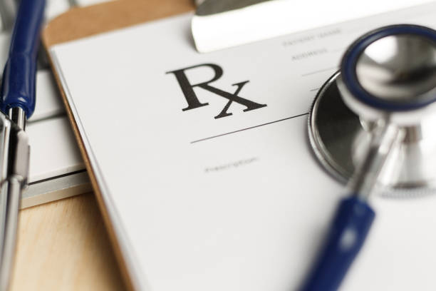 Prescription form clipped to pad lying on table stock photo