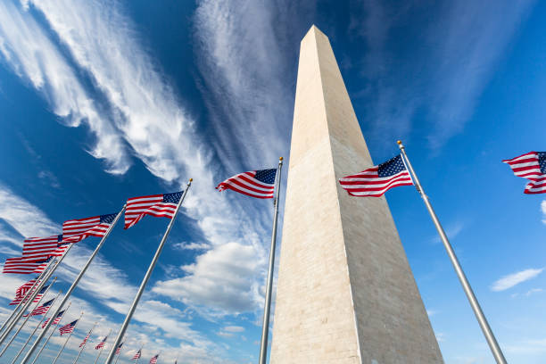 Flags by the Washington Monument Washington Dc: The Washington Monument is an obelisk on the National Mall in Washington, D.C., built to commemorate George Washington national monument stock pictures, royalty-free photos & images