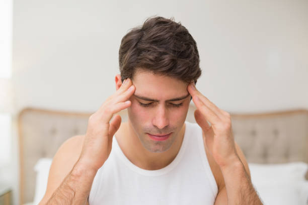 istock Close up of a man suffering from headache in bed 852410722