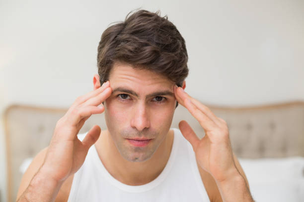 istock Close up of man suffering from headache in bed 852410752