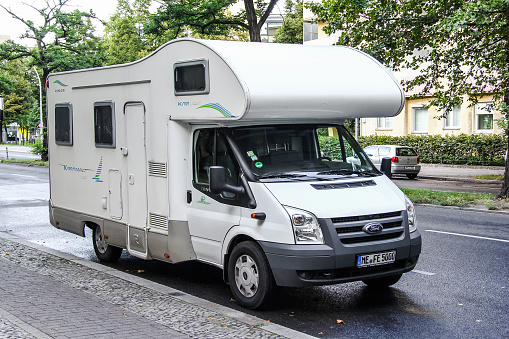 BERLIN, GERMANY - AUGUST 16, 2014: White caravan Ford Transit in the city street.