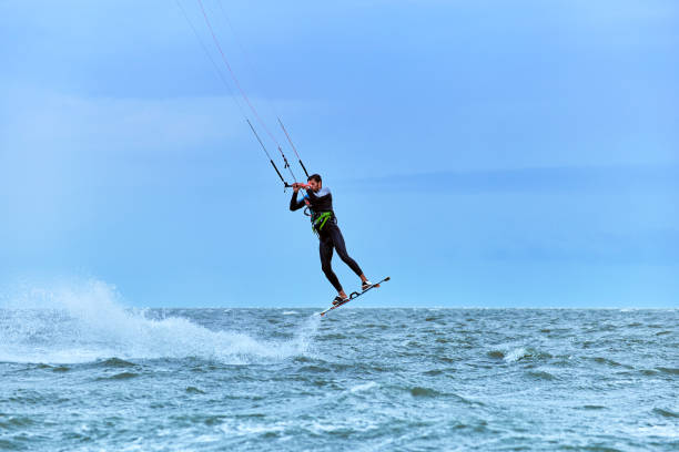 istock Man riding a kite surfing on the waves in the summer. 852419084