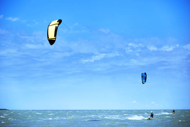 istock Man riding a kite surfing on the waves in the summer. 852419102