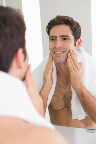 istock Man looking at self in mirror in the bathroom 852419568