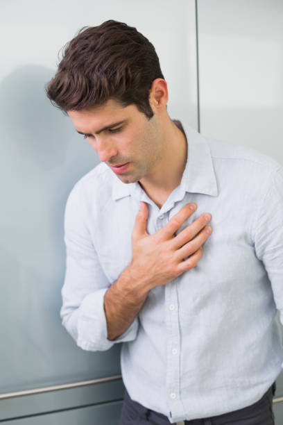 istock Casual young man with chest pain 852422558