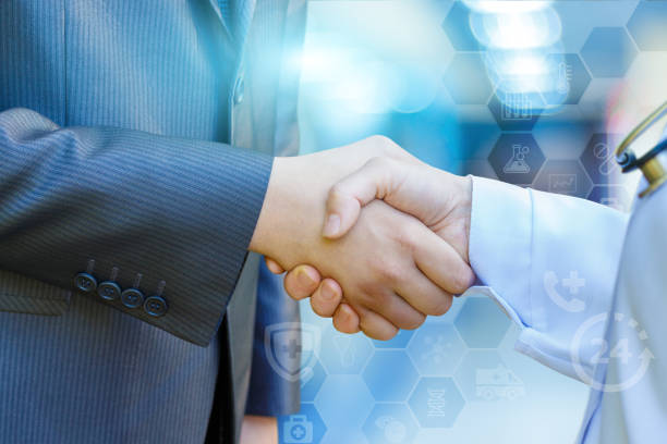 istock Health worker shakes hands with the patient . 852425220