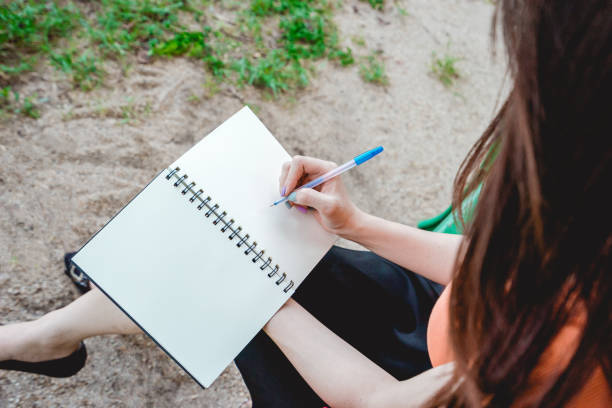 istock Girl write the note in the park. 852426130