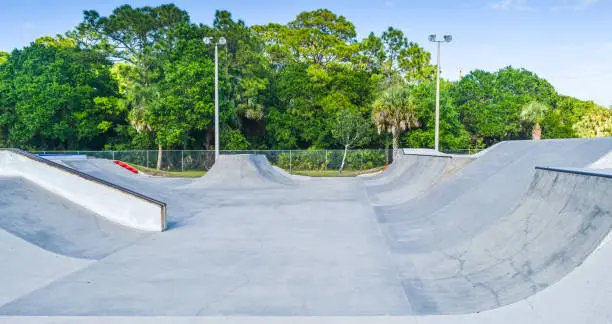 Inside a skate park, with ramps, shelter and night lights