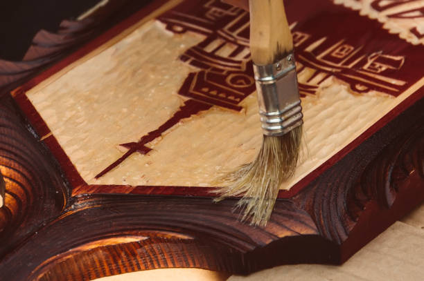istock man paints a wooden box. 852442060
