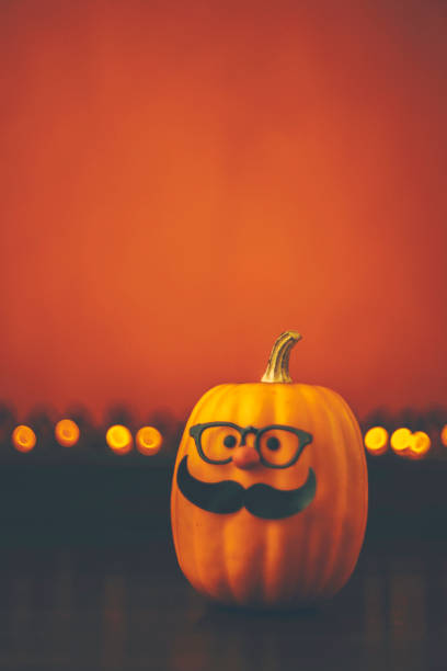 istock Cute pumpkin halloween character on bright orange background 852442308