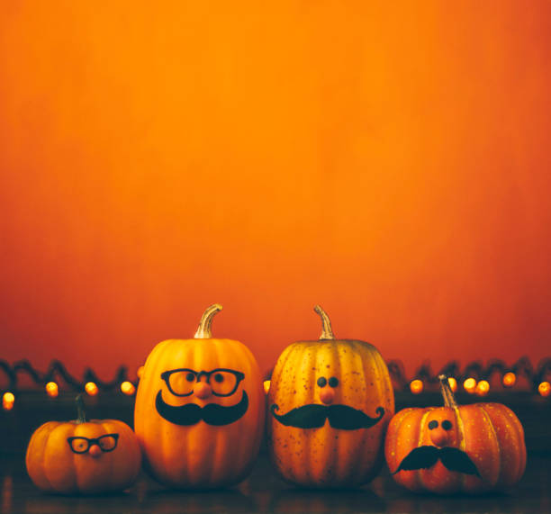 istock Cute pumpkin halloween characters on bright orange background 852442504