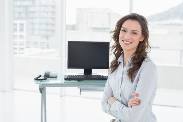 istock Smiling businesswoman in front of computer at office 852442958