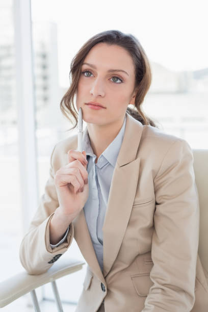 istock Thoughtful elegant businesswoman with pen in office 852445792