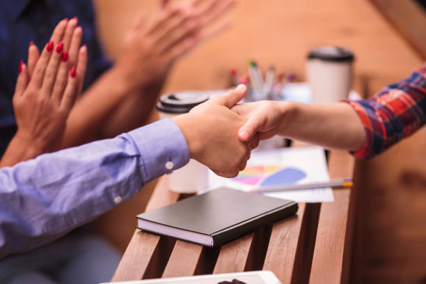istock Close-up handshake of two students outdoors 852453316