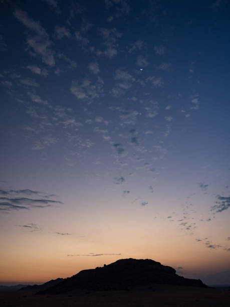 istock Twilight Sunset Namib Desert, Namibia, with U shaped moon 852467434