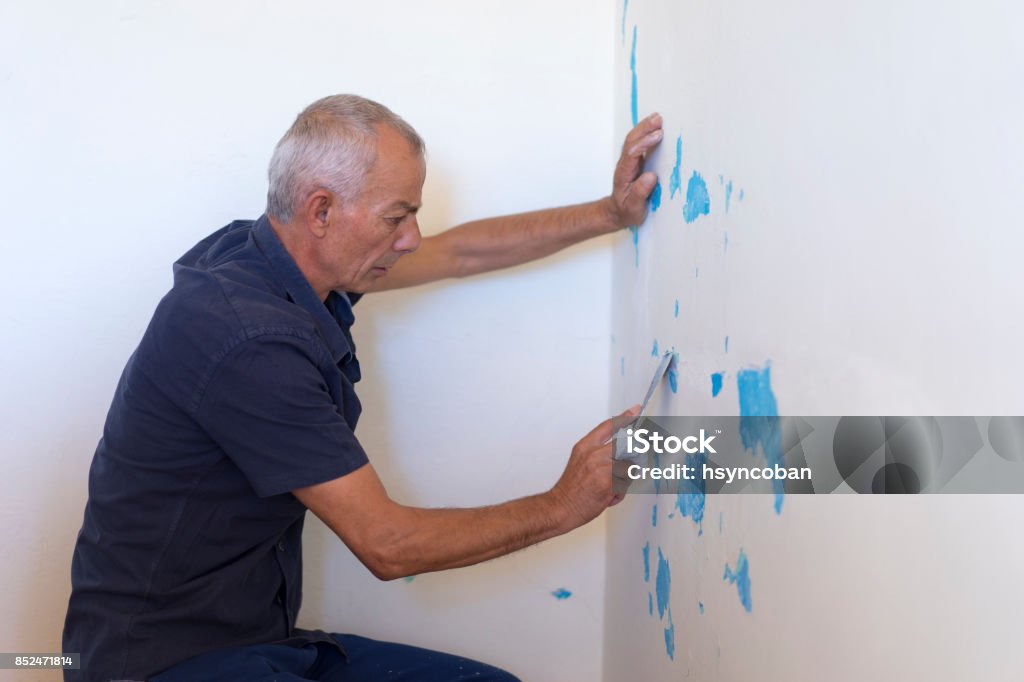 Removing Plaster with a Spatula Paint Stock Photo