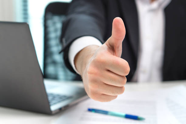istock Business man showing thumbs up in office. 852477940