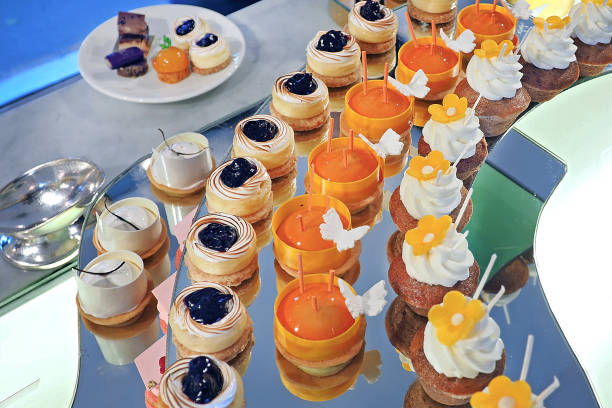 istock assorted of mini cup cakes display at cake shop, blueberry cheese, chocolate orange and macaroon 852482308
