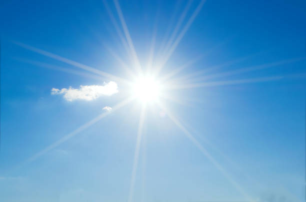 istock blue sky with clouds and sun reflection.The sun shines bright in the daytime in summer 852486574
