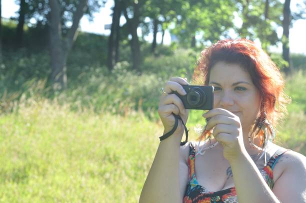 istock woman taking picture  in a park 852498888