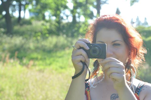 istock woman taking picture  in a park 852499184