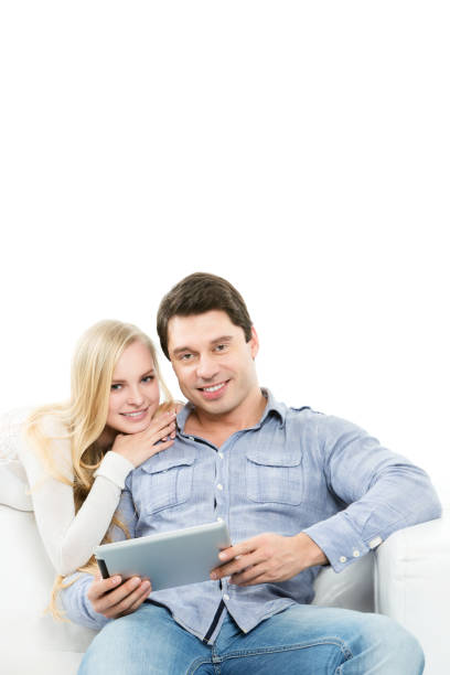istock Smiling couple sitting on couch with laptop. 852502096