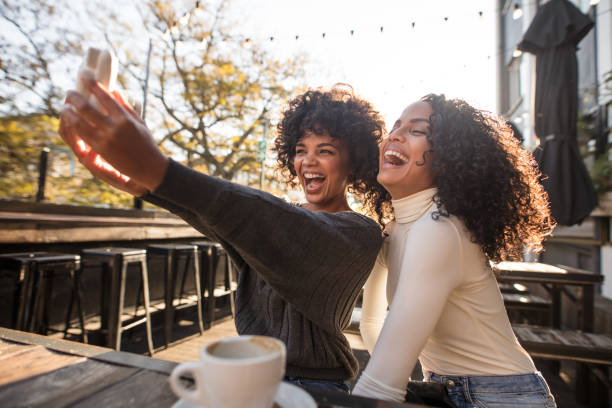 istock Two young women having fun taking a selfie 852502108