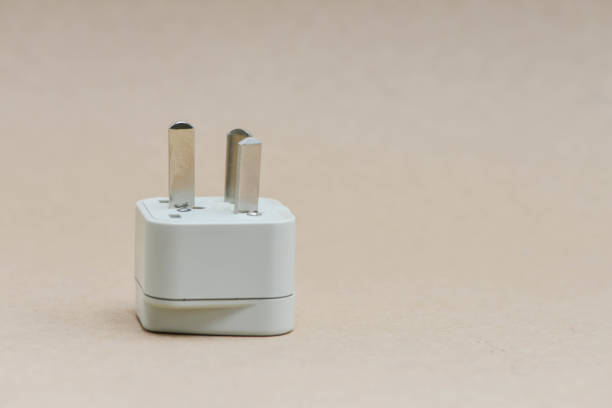 Electric travel plug on the brown background