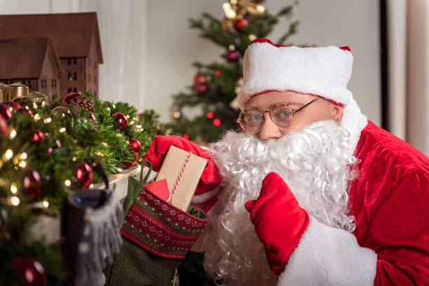 istock Joyful bearded man in red costume preparing presents on Christmas 852512136