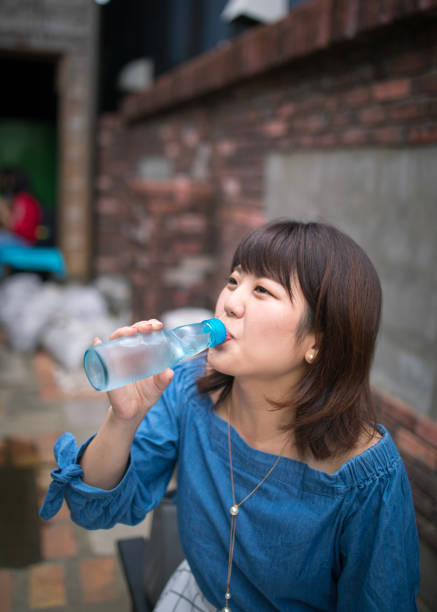 istock Young woman drinking soda in old town 852513066