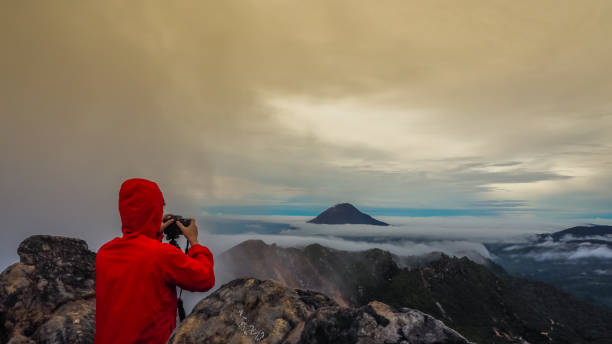 istock Freedom man standing on top of Mount Sibayak 852515850