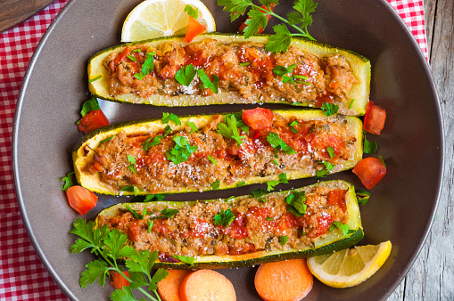 Zucchini stuffed with meat, vegetables and herbs