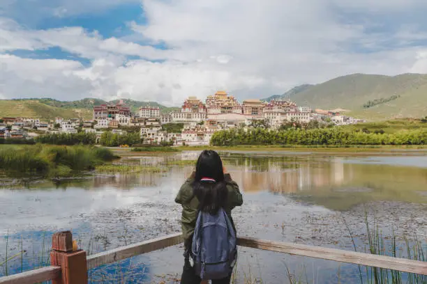 Female tourists are traveling in Little Potala Palace Lamasery"nThe famous temple in shangri-la , yunnan , china