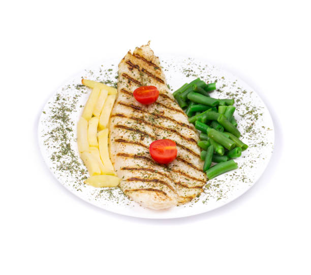 istock Grilled fish with potatoes and peas on the white plate. 852547900