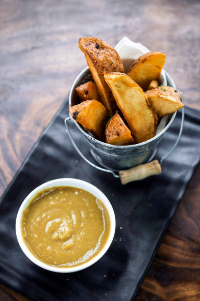 fried potato wedges with curry sauce snack food