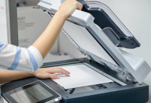 istock Business woman is using the printer to scanning and printing document 852556556
