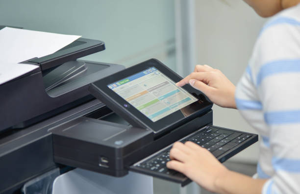 istock Business woman is using the printer to scanning and printing document 852556654